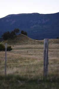 Scenic view of field and mountains against sky