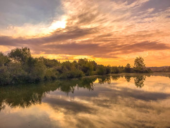 Scenic view of lake against orange sky