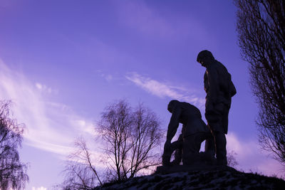 Low angle view of statue against cloudy sky