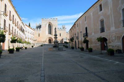 Alley amidst buildings against sky