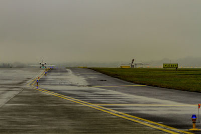 Road by airport against sky