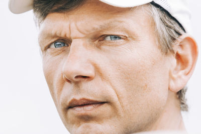 Close-up portrait of man against white background