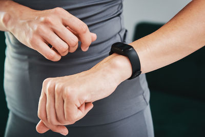 Woman use fitness tracker and doing sport exercise at home