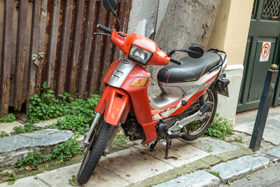 Motor scooter parked on footpath in yard