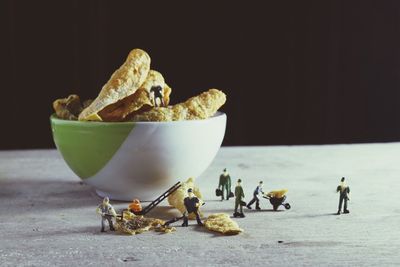 Close-up of figurine in bowl on table