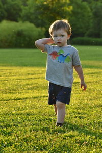 Full length of cute girl on field