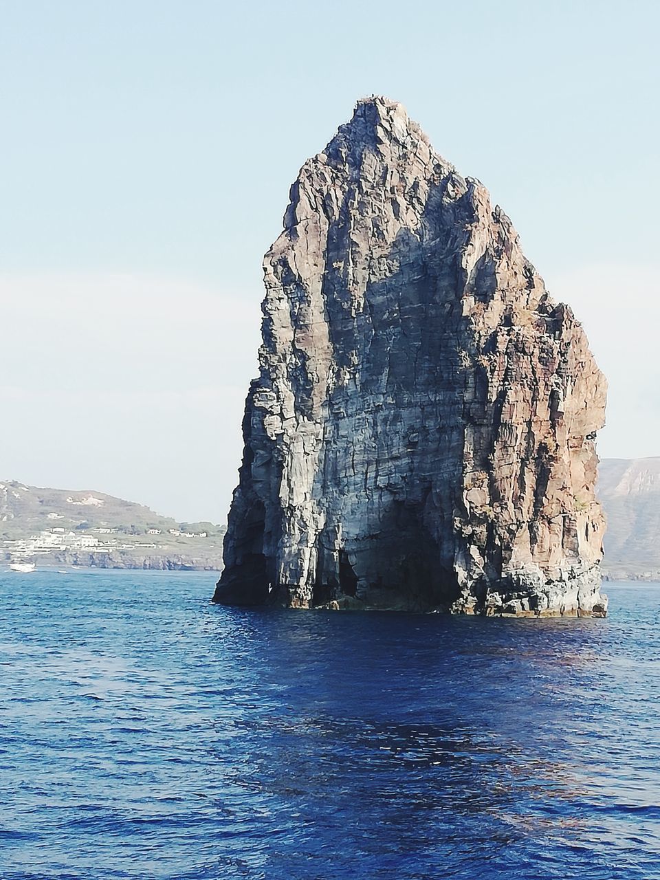 ROCK FORMATION IN SEA AGAINST SKY