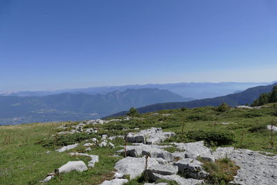 Scenic view of mountains against clear blue sky