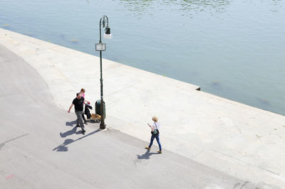 High angle view of people walking on footpath