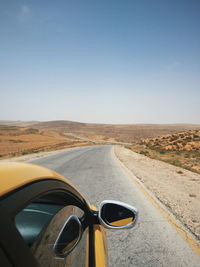 Road in desert against clear sky