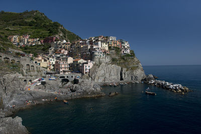 Townscape by sea against clear sky