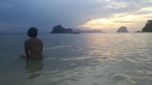 Rear view of man on beach at sunset