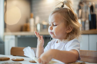 Portrait of cute girl sitting on table