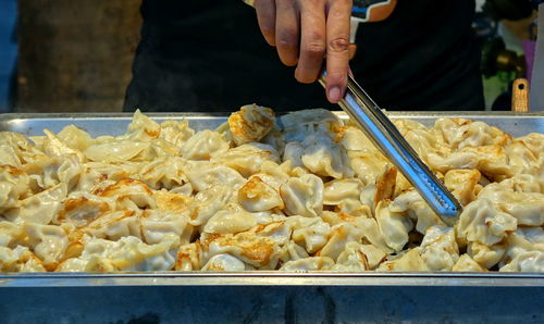 Midsection of man preparing food at concession stand