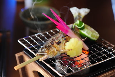 Close-up of fish on barbecue grill