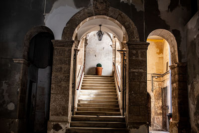 Rear view of man on staircase in old building