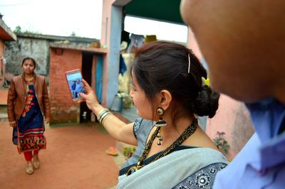 Woman taking selfie with phone