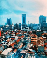 High angle view of modern buildings in city against sky