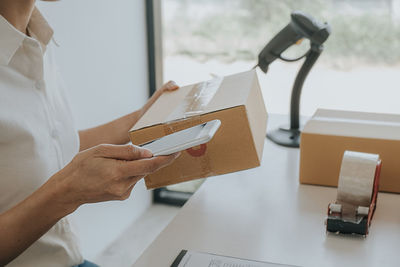 Midsection of woman working on table