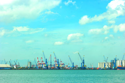 Commercial dock by sea against sky