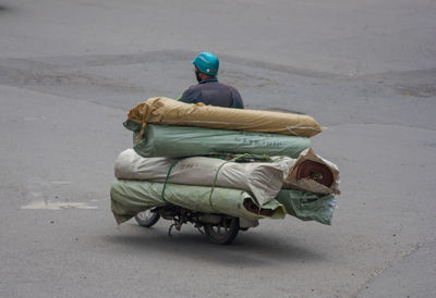 Rear view of man sitting on road