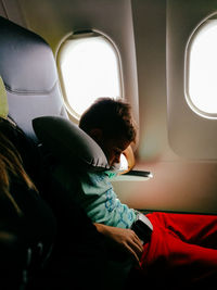 Boy sleeping in airplane