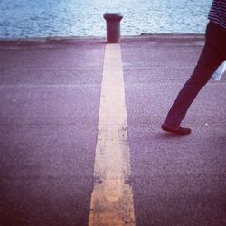 Low section of person standing on tiled floor