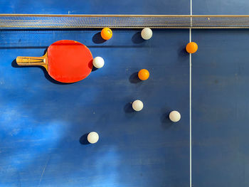 Low angle view of balloons on table against wall