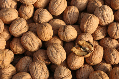 A group of walnut and coincidently one is cracked shell 