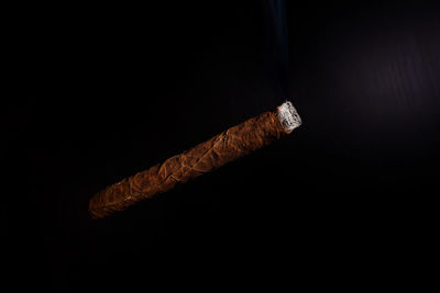 Close-up of cigarette against black background