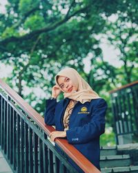 Woman standing on railing