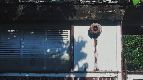 Low angle view of rusty window on building