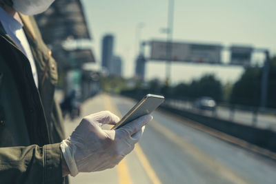 Man using mobile phone in city