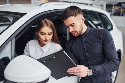 Portrait of woman using mobile phone while sitting in car