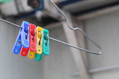 Close-up of multi colored clothespins on clothesline