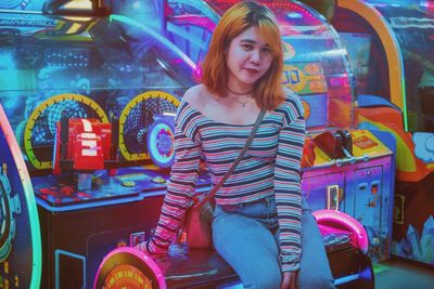 Portrait of a smiling young woman on arcade