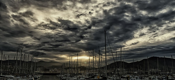 View of harbor against cloudy sky