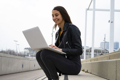 Woman using her white laptop.