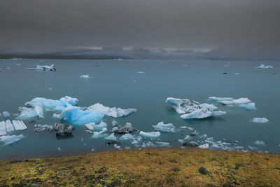 Scenic view of frozen lake against sky