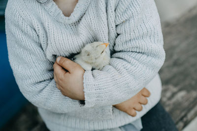 Child holding chick