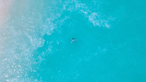 Woman swimming in sea in maldives islands