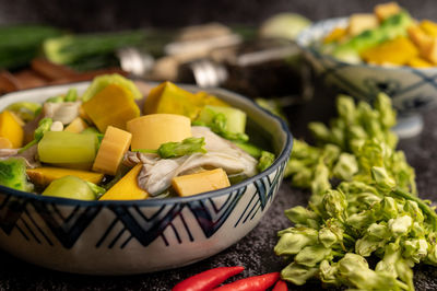 Close-up of chopped fruits in bowl on table