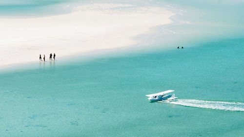 High angle view of people walking on beach