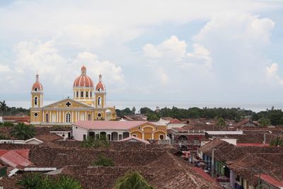 Church in city against cloudy sky