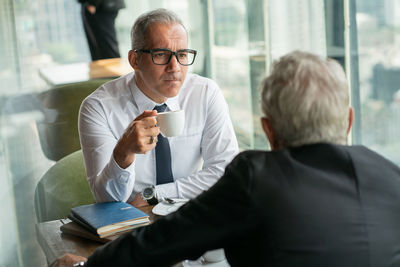 Man and woman sitting in office