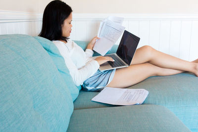 Young asian woman studies with laptop from home