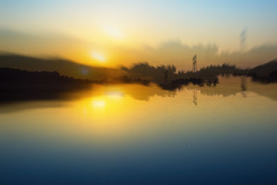 Scenic view of lake against sky during sunset