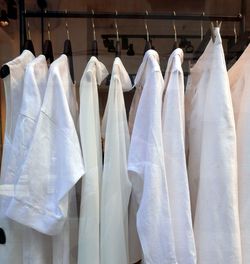 White cloths with hangers on clothing rail