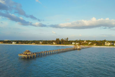 Scenic view of sea by buildings against sky