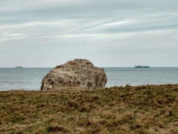 Scenic view of sea against cloudy sky